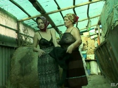 Two old village wome fuck each others cunts with the help of strapon